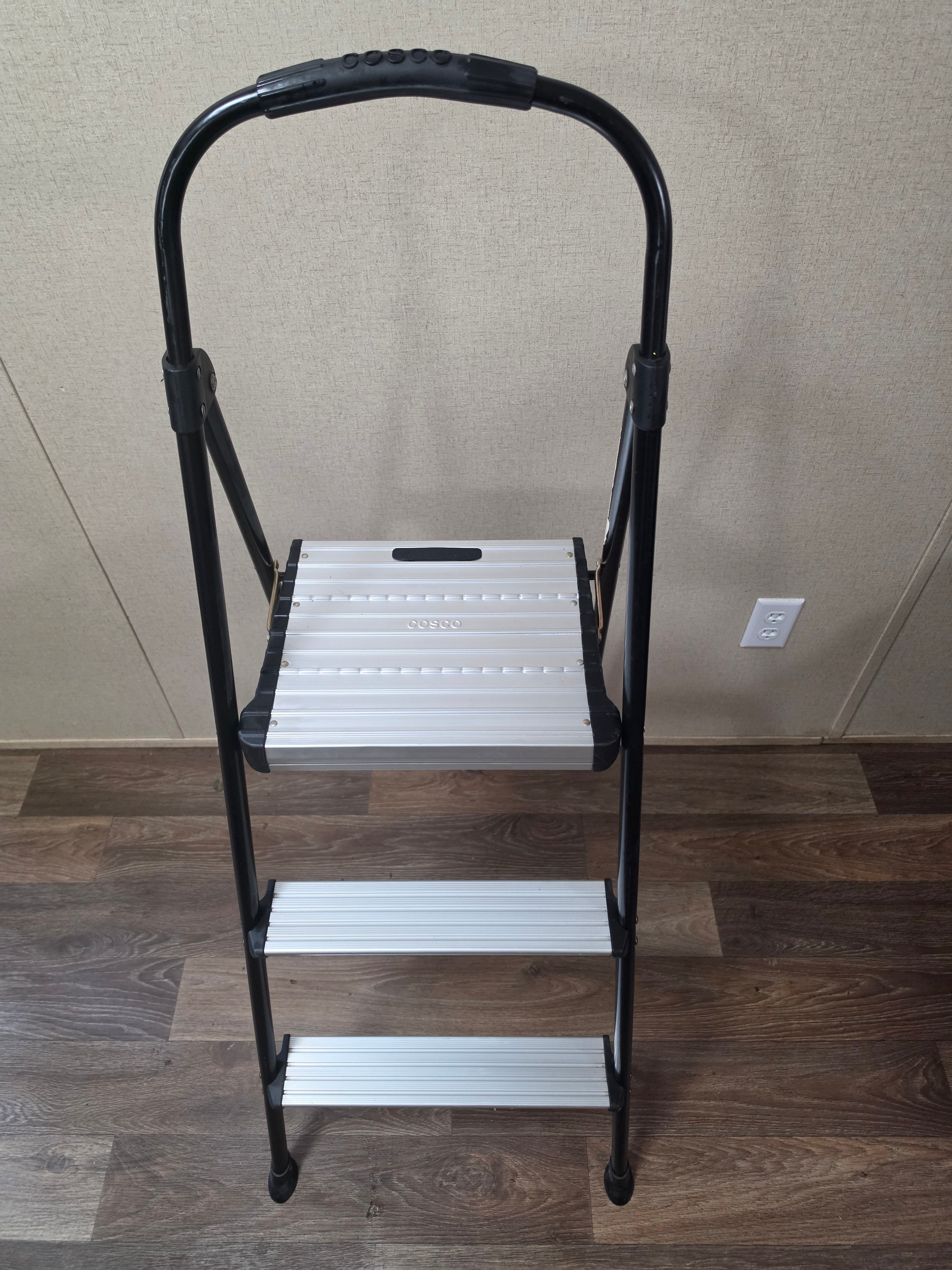 Front-left angled view of the open Cosco three-step folding ladder and top platform.