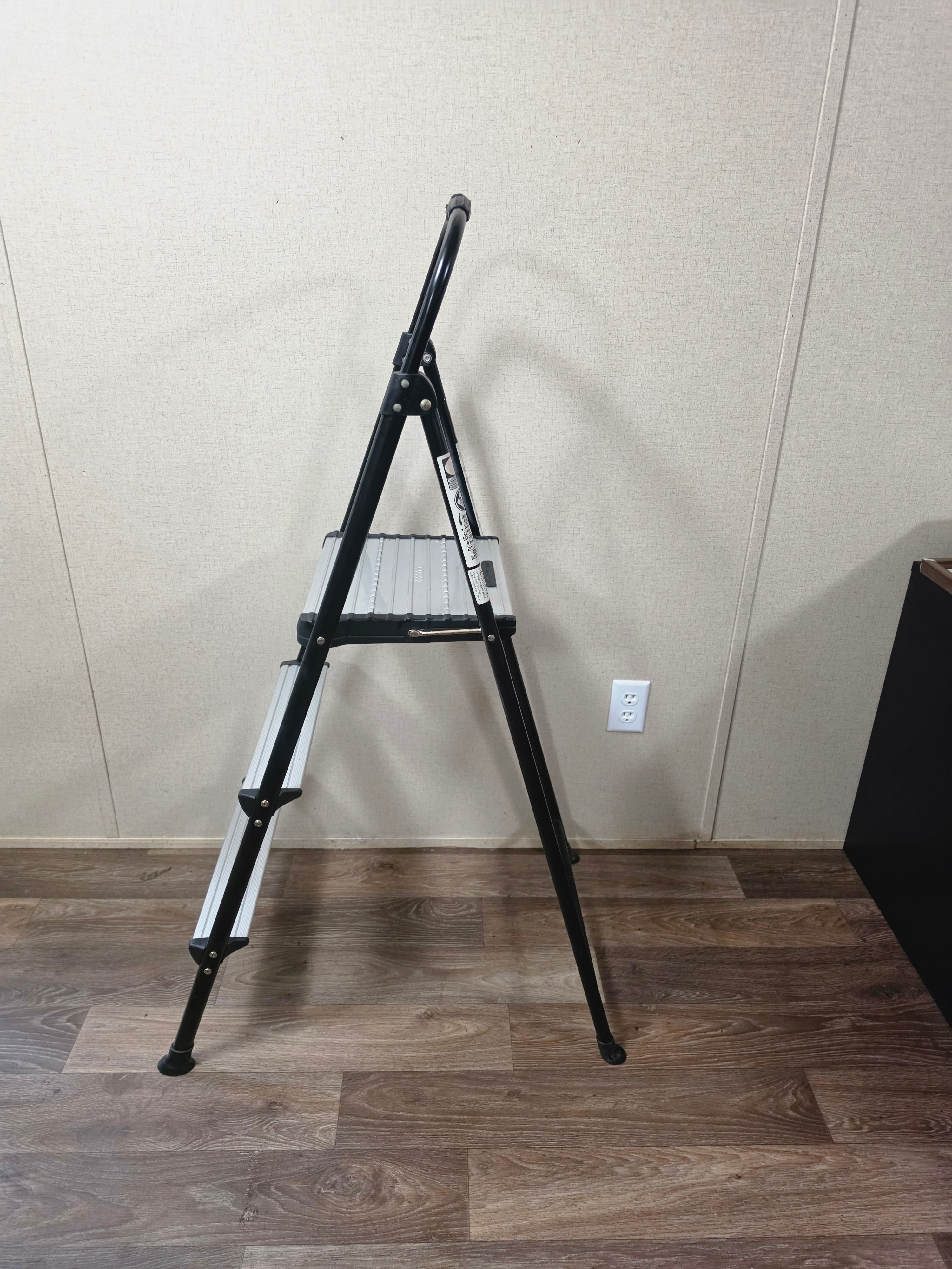 Side profile of the open Cosco folding ladder showing its A-frame stance.