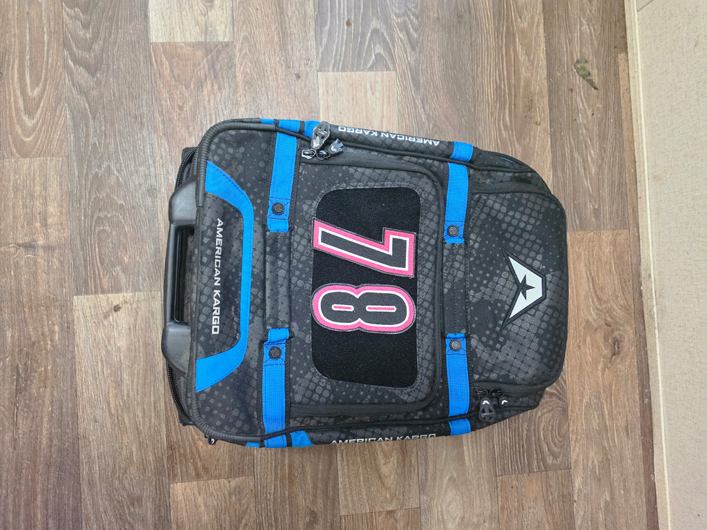 Top view of the American Kargo roller bag lying flat with the custom 78 patch visible.