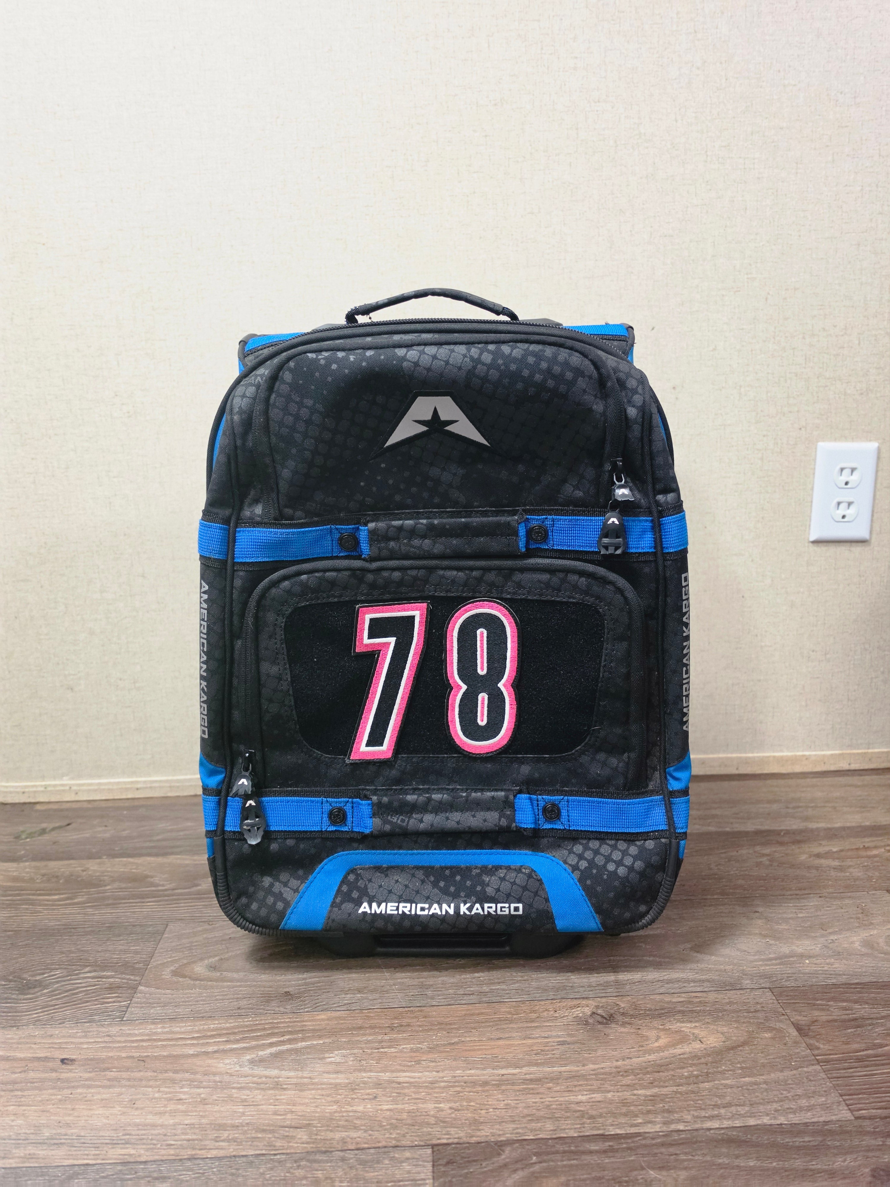 Front view of the black and blue American Kargo roller gear bag with custom 78 patch.