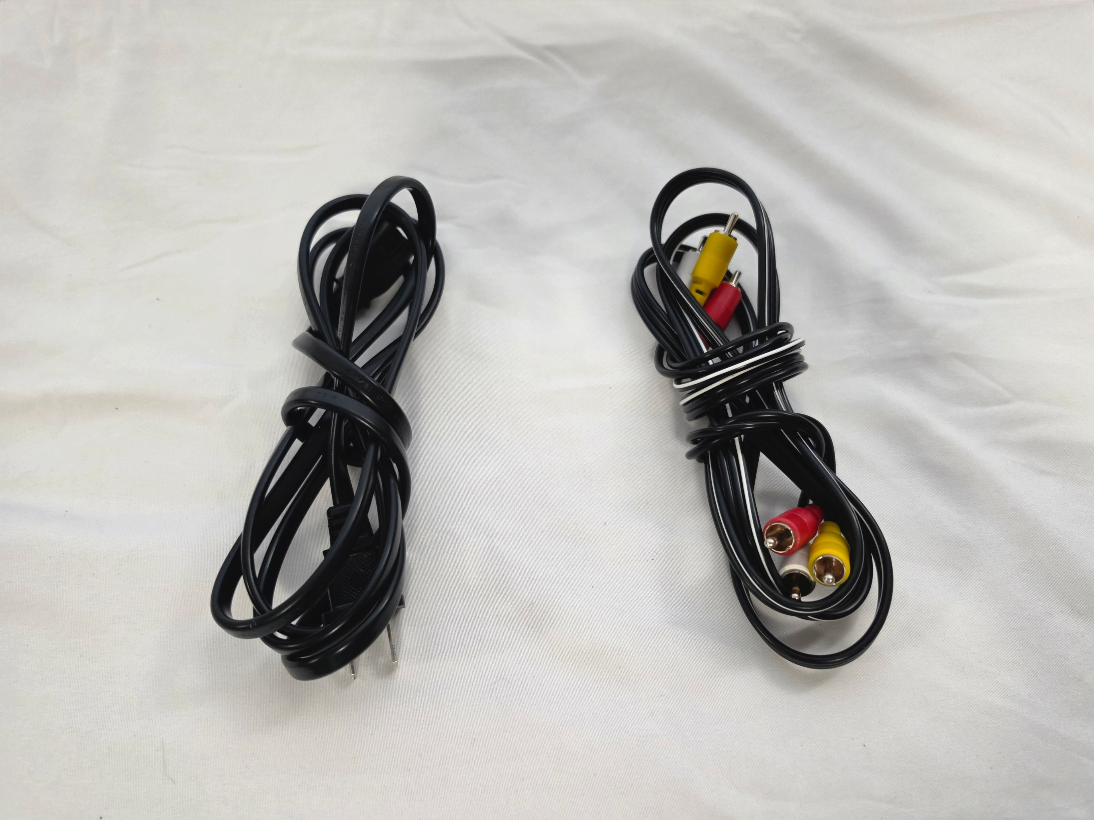 Included black power cord and red, white, and yellow composite AV cable.
