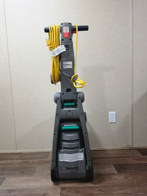 Rear view of the BISSELL BigGreen commercial carpet cleaner with yellow power cord wrapped on the handle.