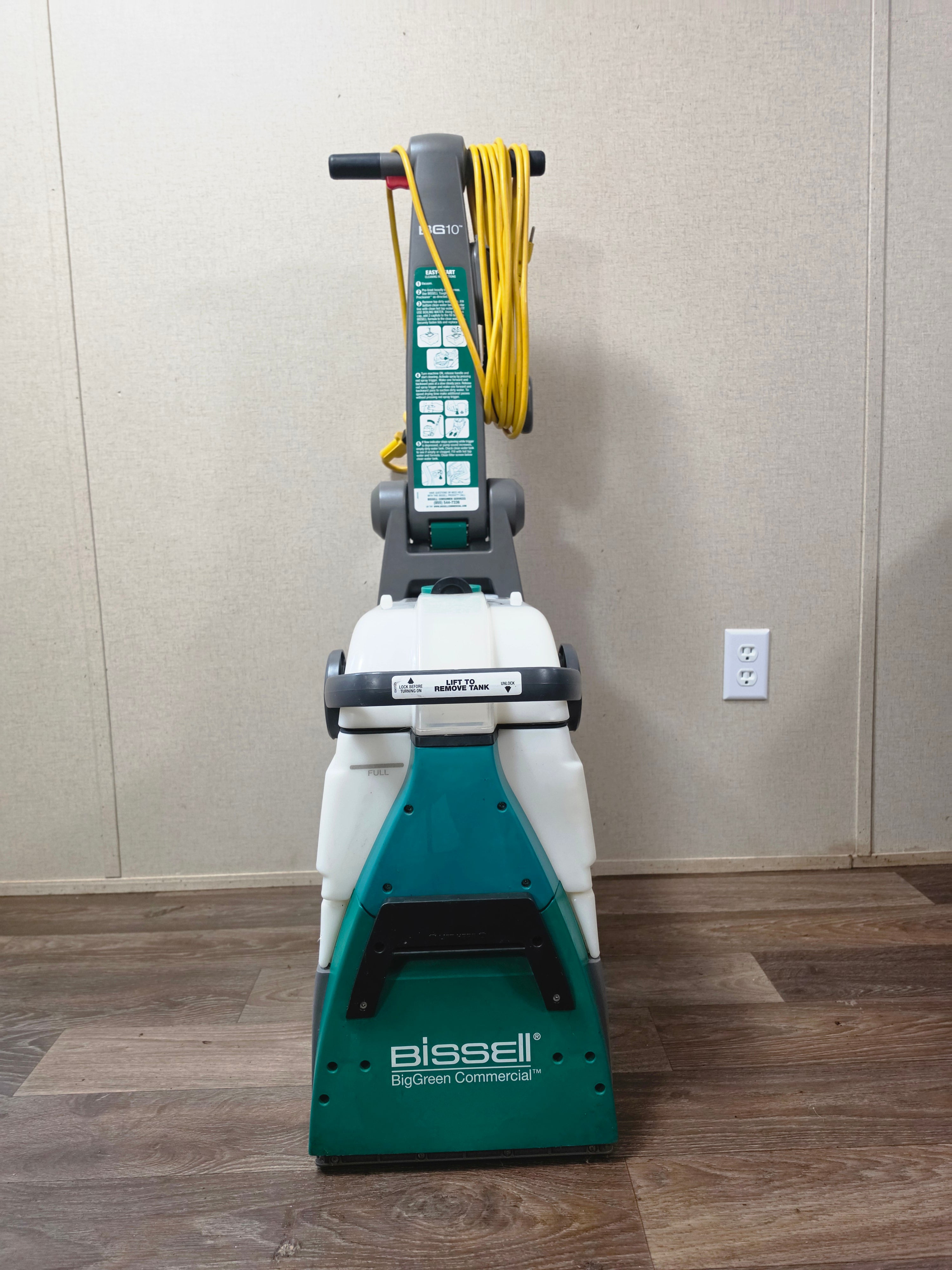 Front view of the green and gray BISSELL BigGreen commercial carpet cleaner.