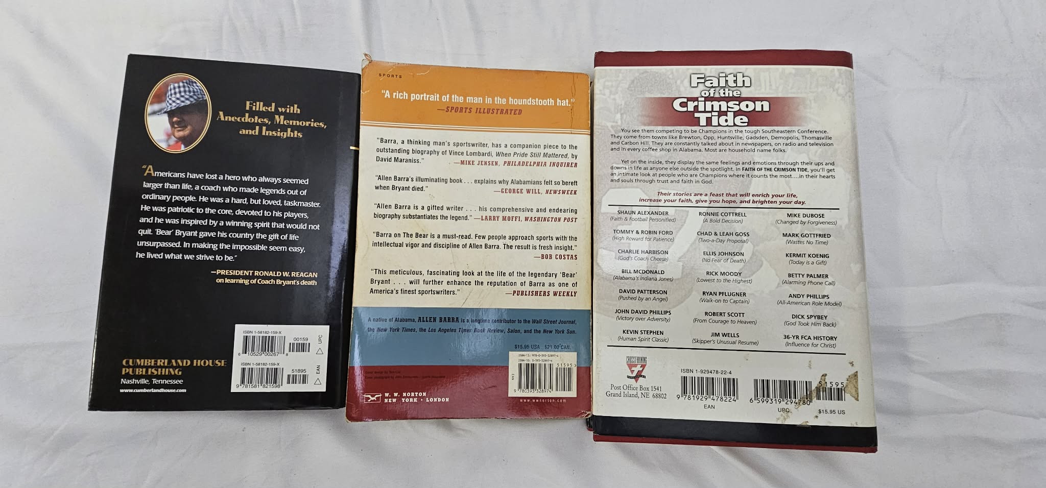 Back covers of three pre-owned football books arranged side by side.