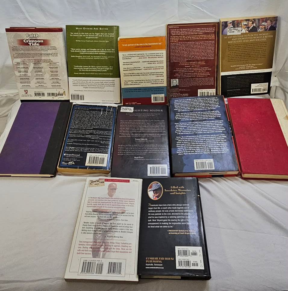 Back covers of all twelve pre-owned football and sports books arranged for condition review.