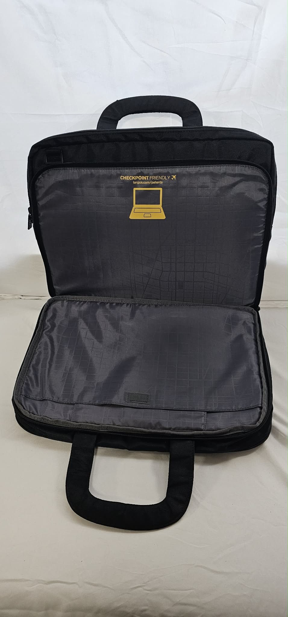 Open Targus SafePORT briefcase showing the gray padded interior and organizer pockets.