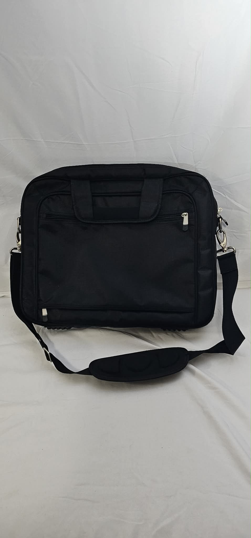 Rear view of the black Dell laptop briefcase with carry handles, rear zippered pocket, and padded shoulder strap.