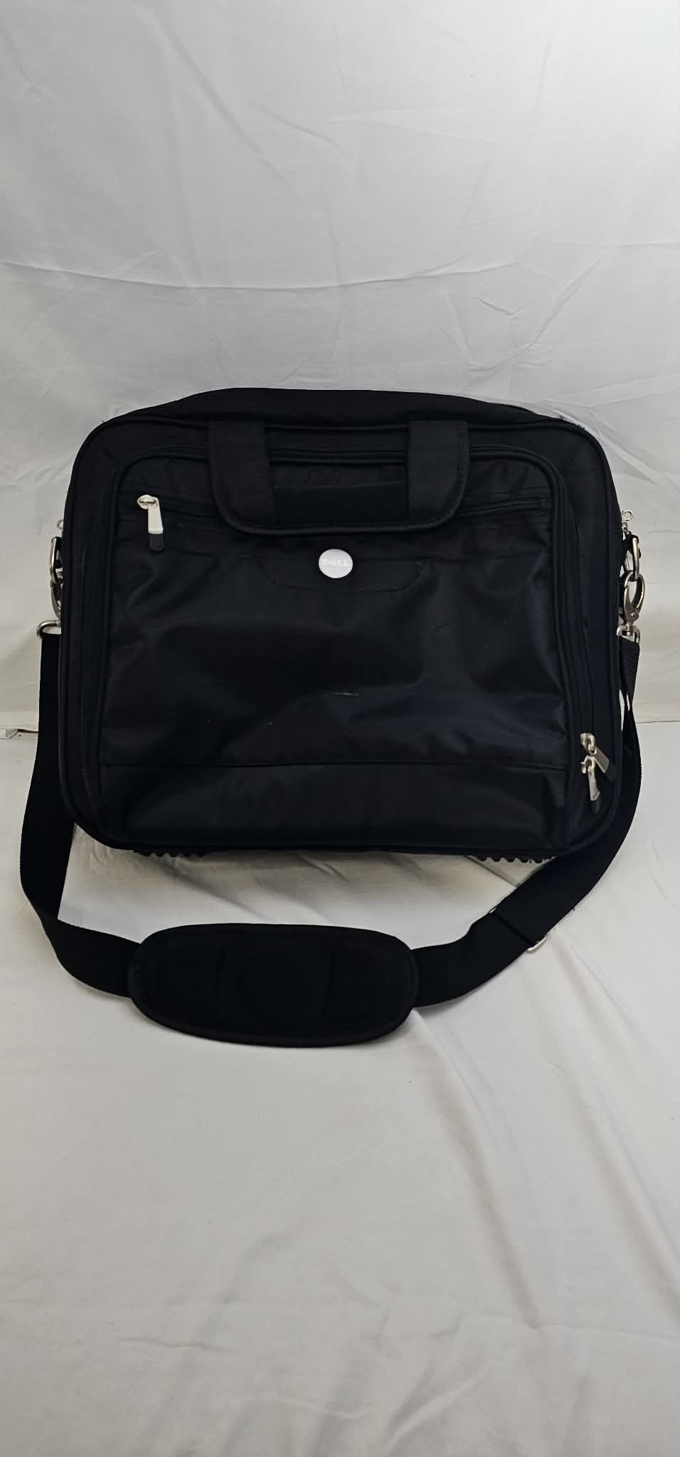 Front view of a black Dell padded laptop briefcase with carry handles, zippered pockets, and detachable shoulder strap.